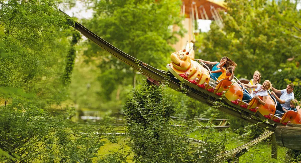 Familie genießt eine Fahrt auf der Raupenbahn im Erlebnispark Tripsdrill bei Heilbronn.