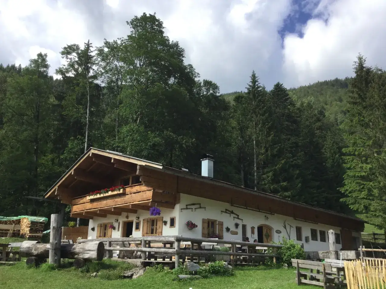 Gem&uuml;tliche H&uuml;tte mit Holzverkleidung und Blumenk&auml;sten, ideal f&uuml;r eine Feldlahnalm Wanderung.
